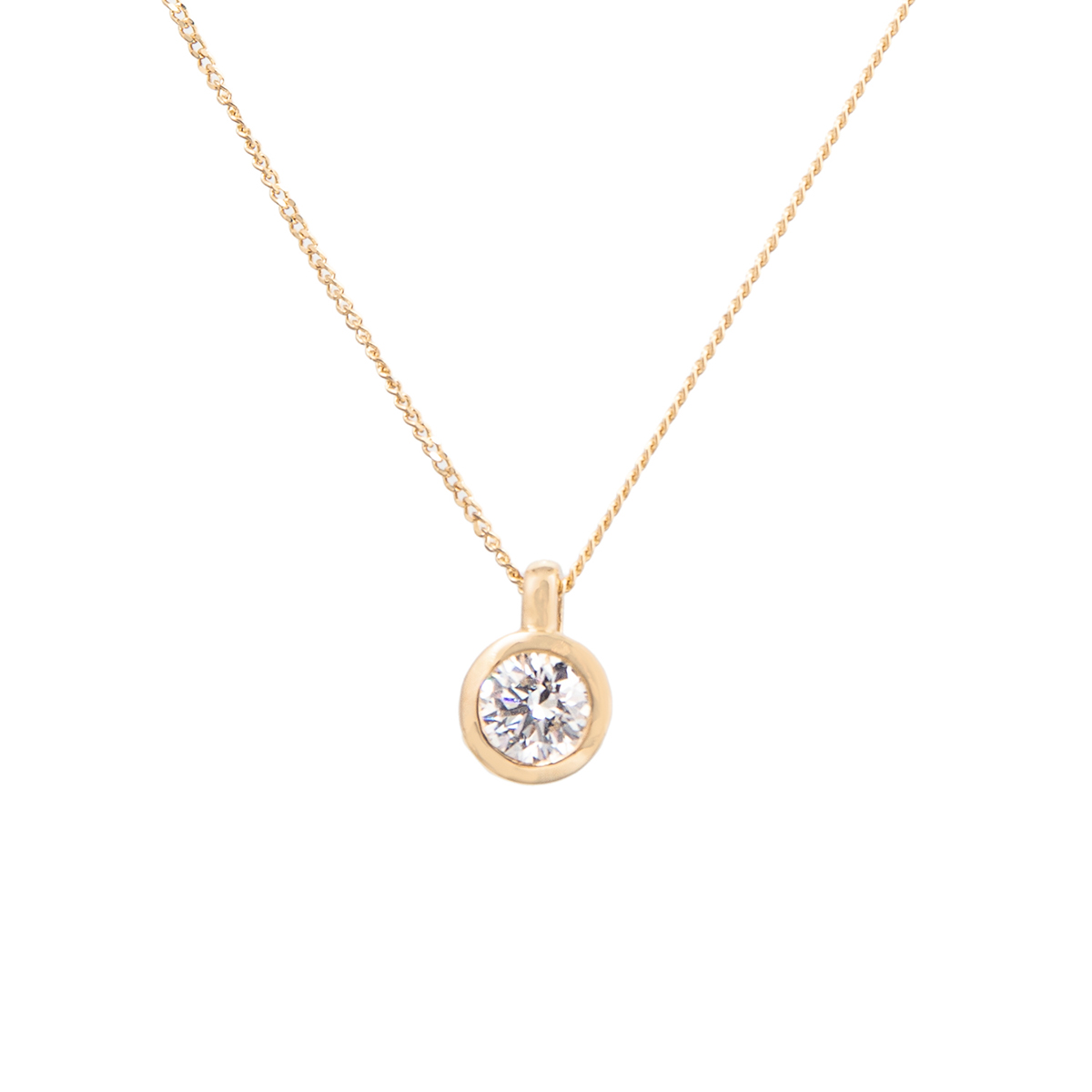 yellow gold diamond pendant in a rubbed over setting