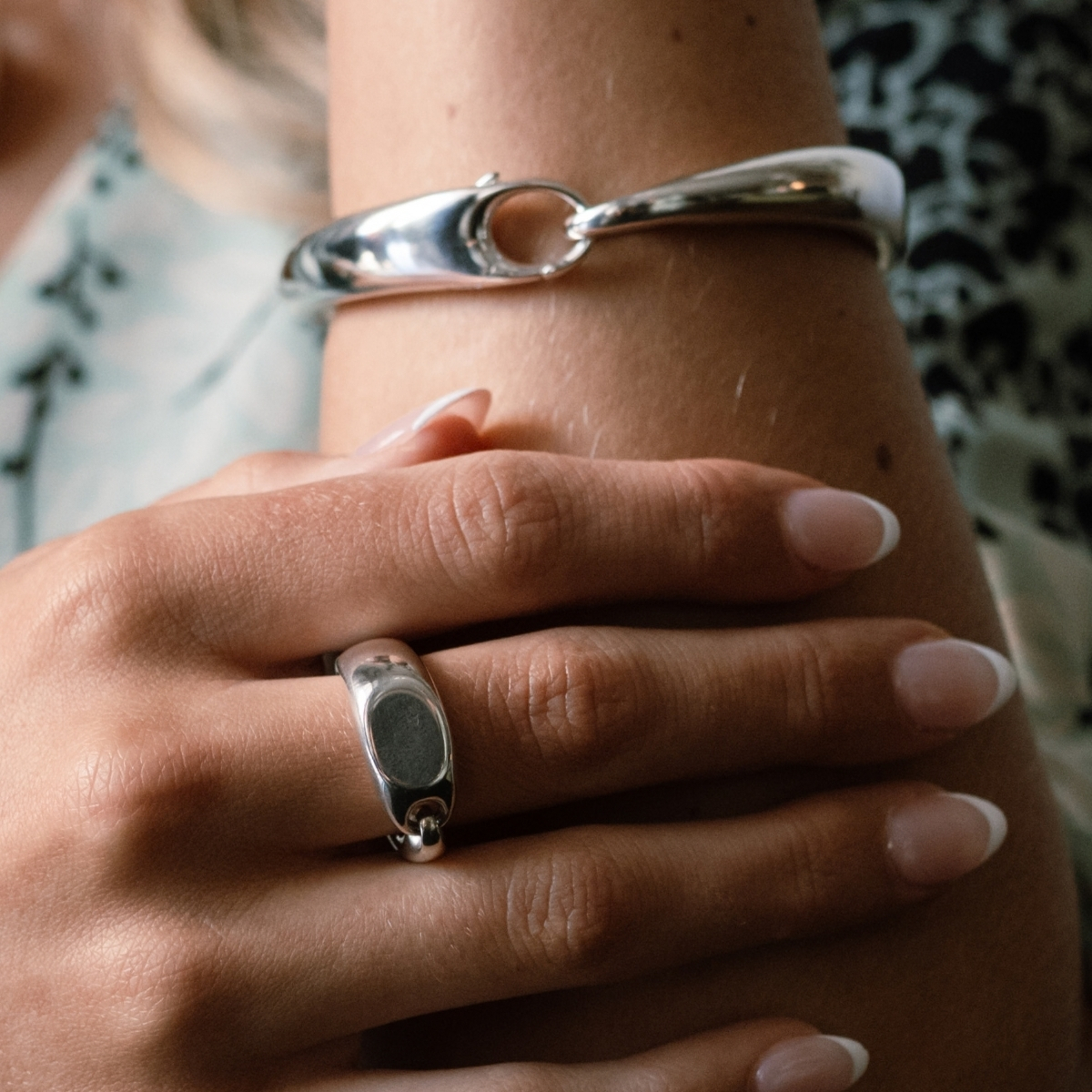 Georg Jensen Reflect signet ring in sterling silver, worn with the Reflect bangle.