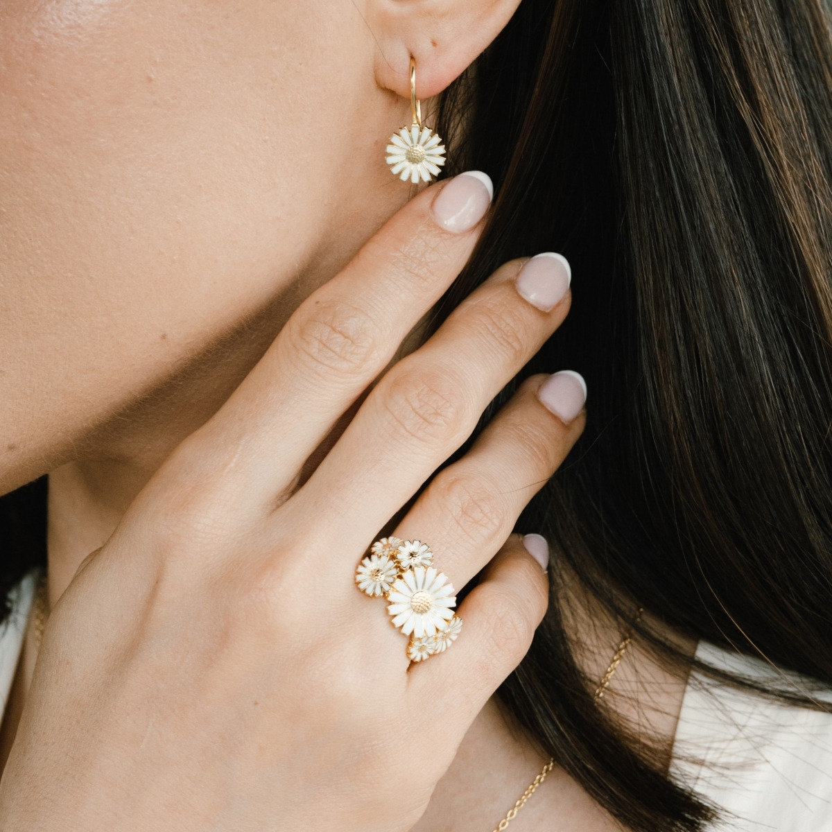 Georg Jensen Layered Daisy ring in gold-plated silver, worn with Daisy drop earrings.
