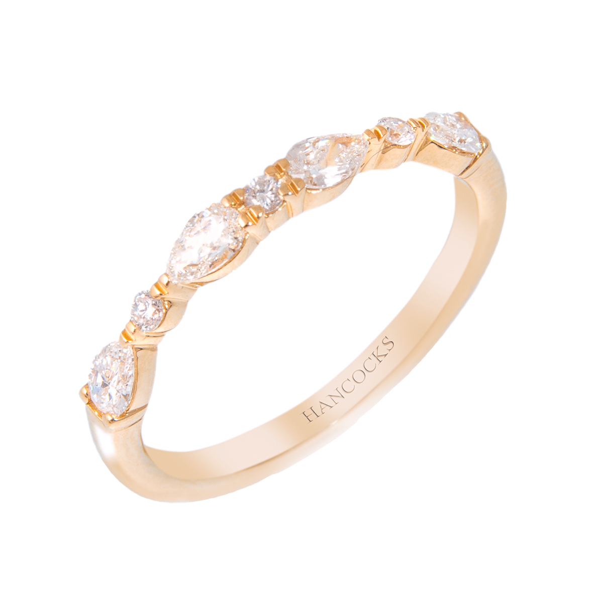 pear and brilliant cut diamond set wedding band in yellow gold