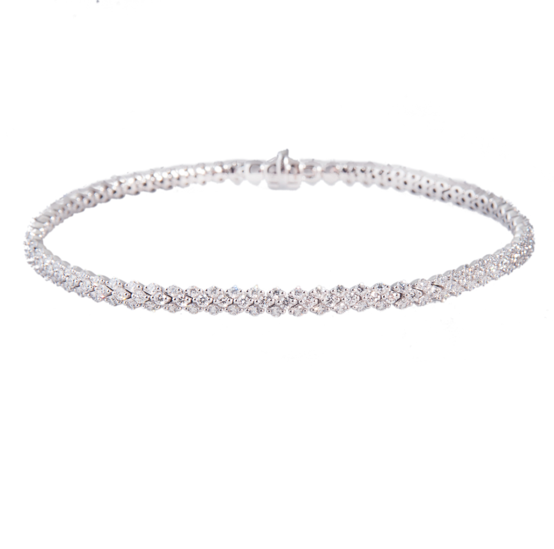 3-row brilliant cut diamond line bracelet on white background. Product photo.