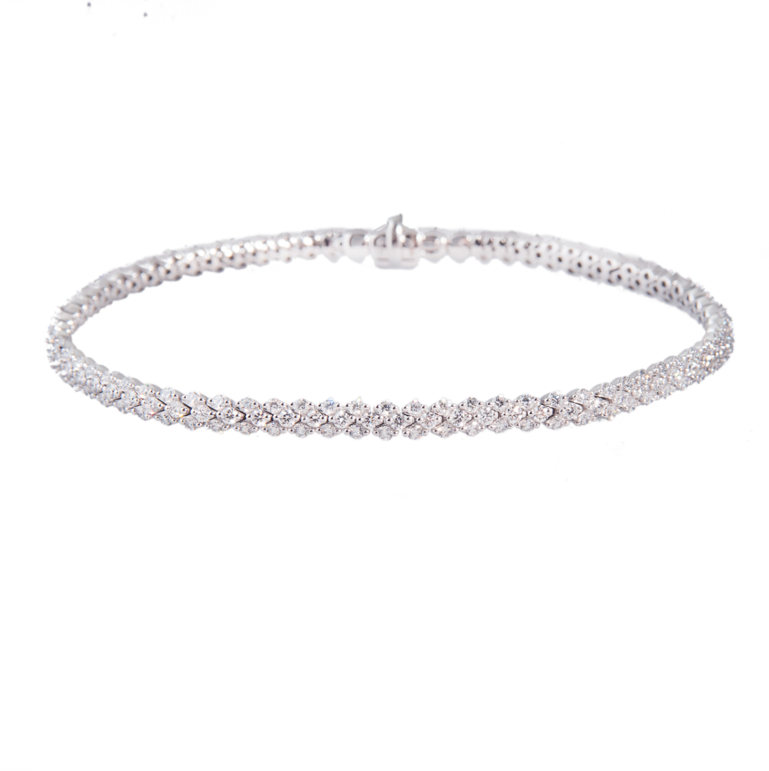 3-row brilliant cut diamond line bracelet on white background. Product photo.
