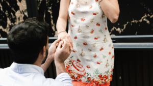 Man proposing with an engagement ring to a woman