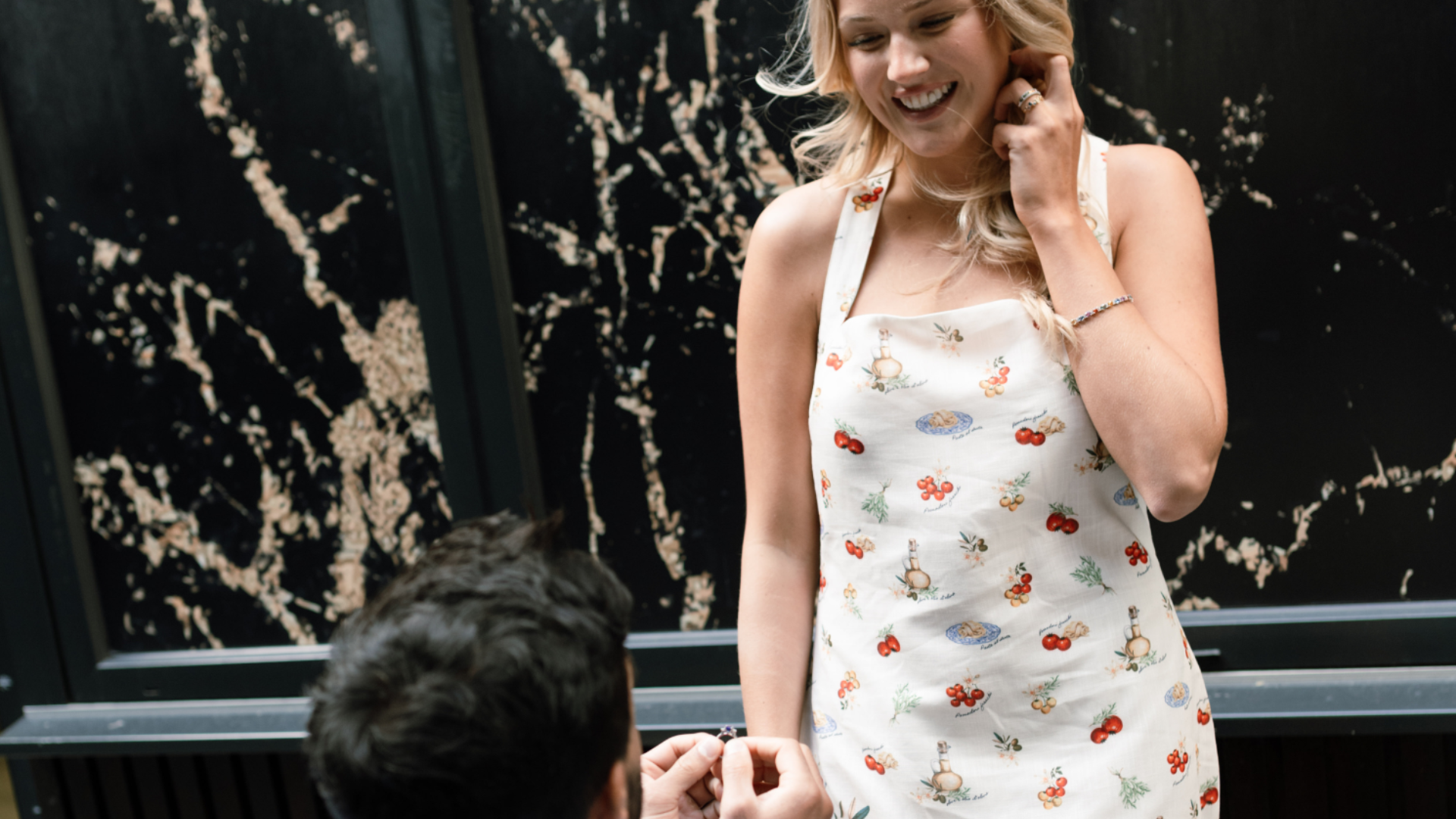 Man proposing with an engagement ring to a woman