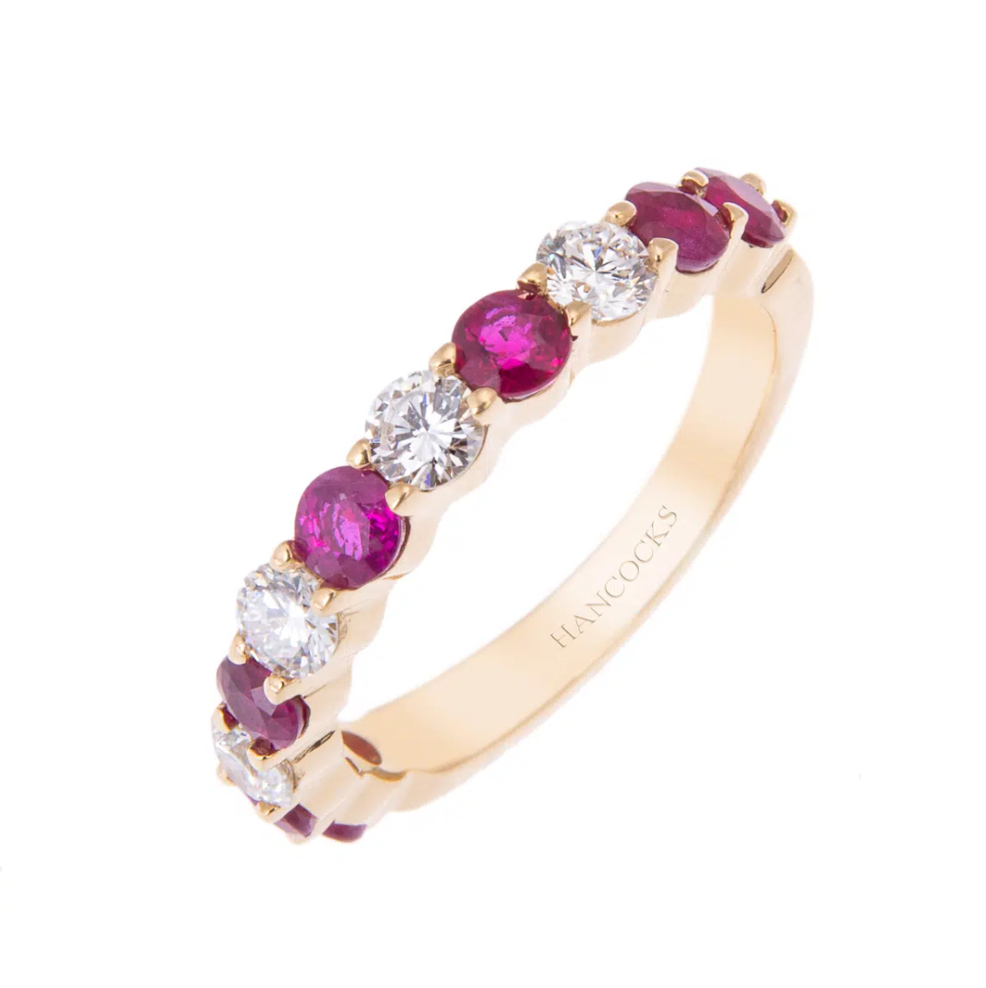 Summer wedding eternity ring on a plain white background. In gold, ruby red and silver.