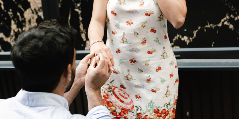 Man proposing with an engagement ring to a woman